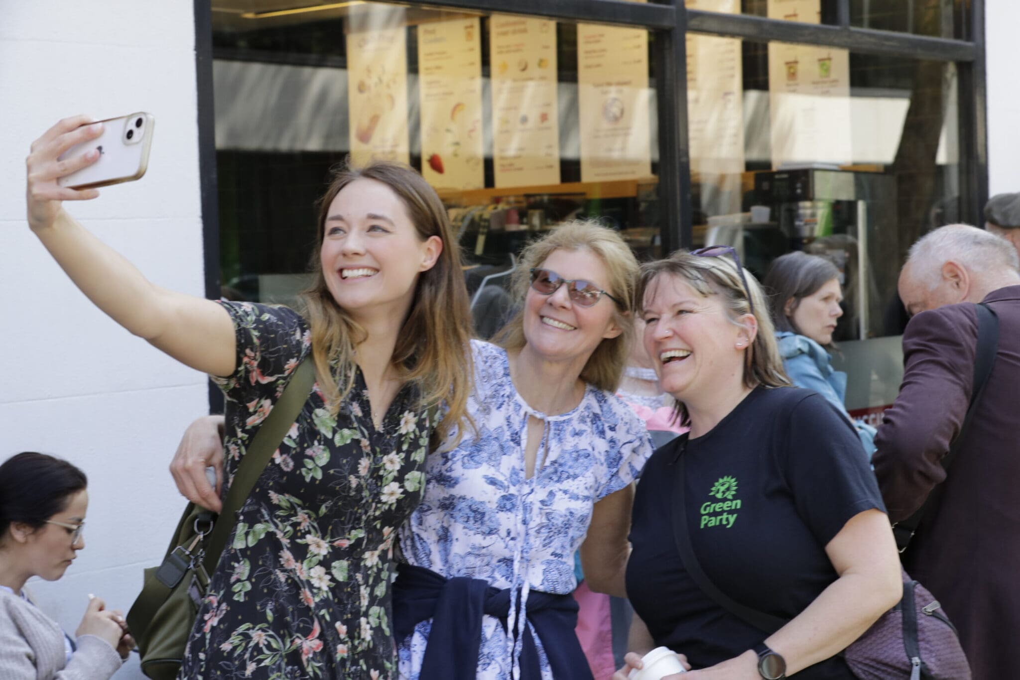 Attendees of Sort the System take selfies in the queue